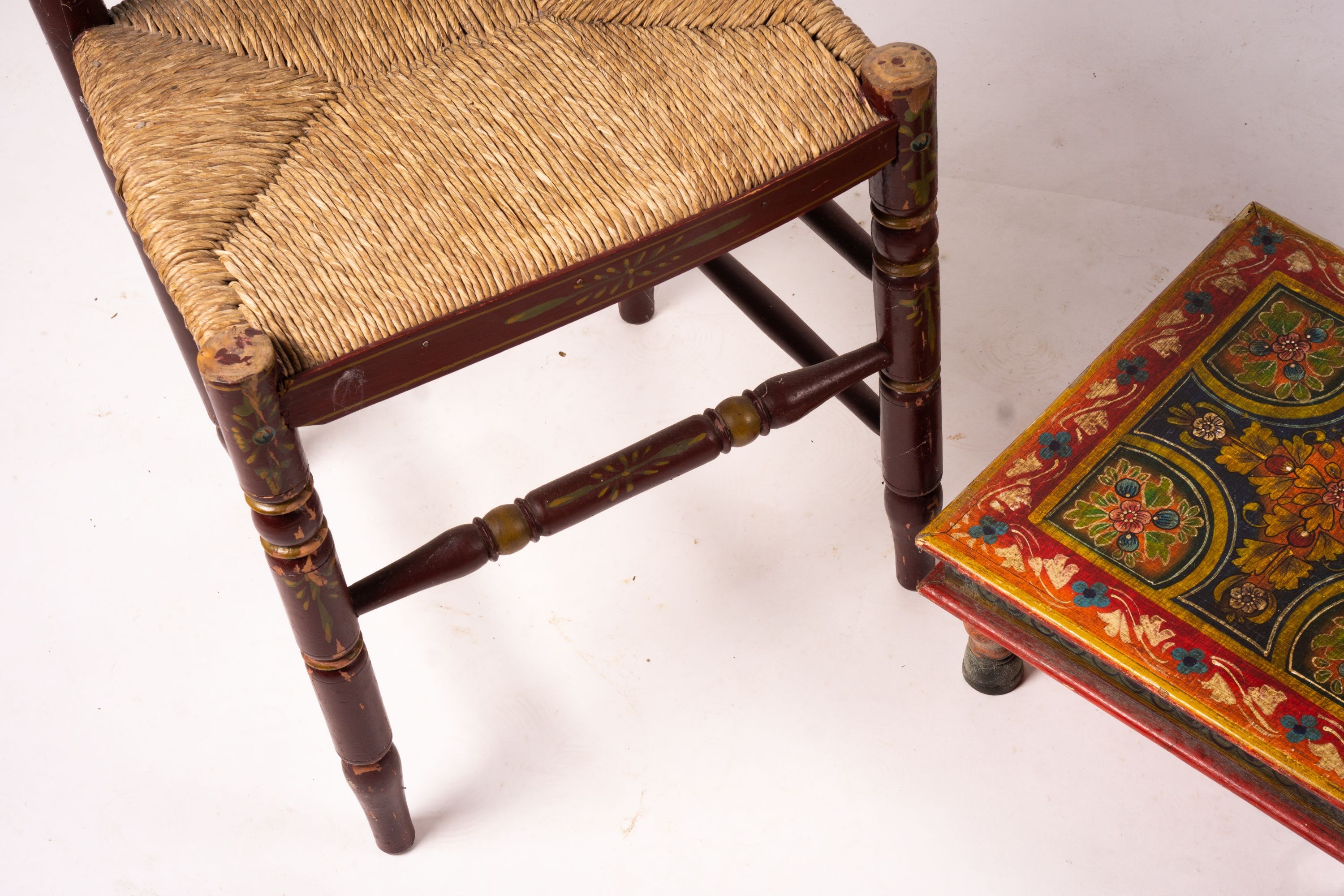 Two 19th / early 20th century Swiss painted rush seat chairs, together with a square low table